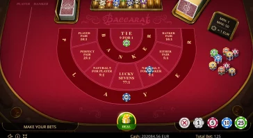 Baccarat table with red felt, betting layout, chips stacked on the right, and a green Deal button at the bottom center.