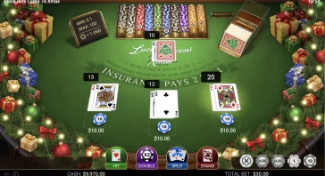 Christmas-themed online blackjack table with gifts and lights; players' cards dealt face up (king and queen of spades, jack of hearts) and chip stacks visible on the felt.