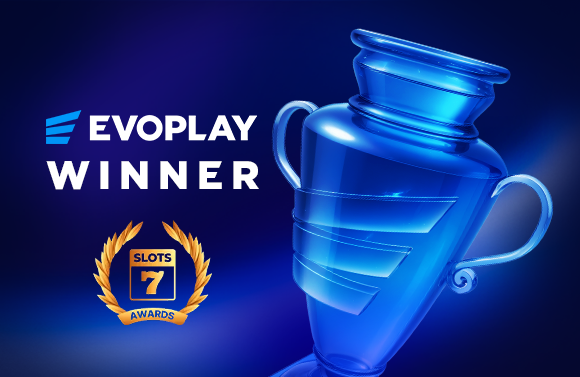 Blue glass trophy tilted to the right with EVOPLAY WINNER text and a Slots 7 Awards emblem on a dark blue background, signaling a winner announcement.
