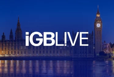 Nighttime view of Westminster Palace and Big Ben along the Thames with the iGB LIVE logo in the foreground (event banner).