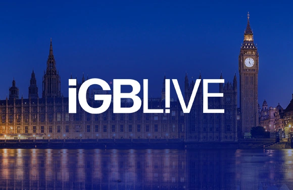 Nighttime view of Westminster Palace and Big Ben along the Thames with the iGB LIVE logo in the foreground (event banner).
