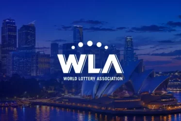 World Lottery Association logo over Sydney Harbour landmarks at dusk with the Opera House and skyline in the background